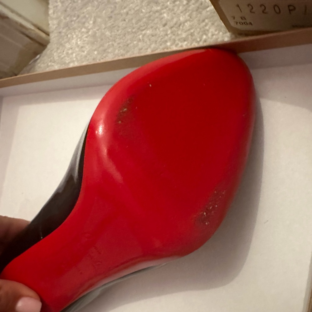 Peep toe black patent leather only worn twice. Still in box and in the red bags